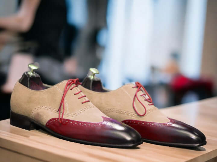 Expertly crafted and uniquely designed, our Men's Two Tone Wing Tip Shoes are the perfect blend of style and quality. The handmade burgundy and beige leather suede adds a touch of sophistication, while the wing tip design offers a classic and timeless look. Elevate your shoe game with these must-have shoes.