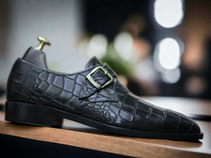 These Handmade Men Black Monk Alligator Shoes are perfect for any formal occasion. Meticulously crafted from premium alligator leather, they provide a comfortable fit as well as classic style. The soles are made from high-quality rubber—durable enough for any situation. With their timeless design, these shoes make a perfect addition to any wardrobe.