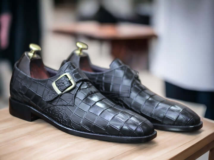 These Handmade Men Black Monk Alligator Shoes are perfect for any formal occasion. Meticulously crafted from premium alligator leather, they provide a comfortable fit as well as classic style. The soles are made from high-quality rubber—durable enough for any situation. With their timeless design, these shoes make a perfect addition to any wardrobe.