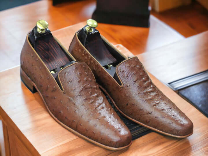 Elevate your look with these men's Ostrich print loafers. Crafted with genuine leather and designed with a timeless silhouette, these loafers are perfect for any formal or smart casual attire. The ostrich print gives these shoes extra texture and style, making you look fashionable and sophisticated.