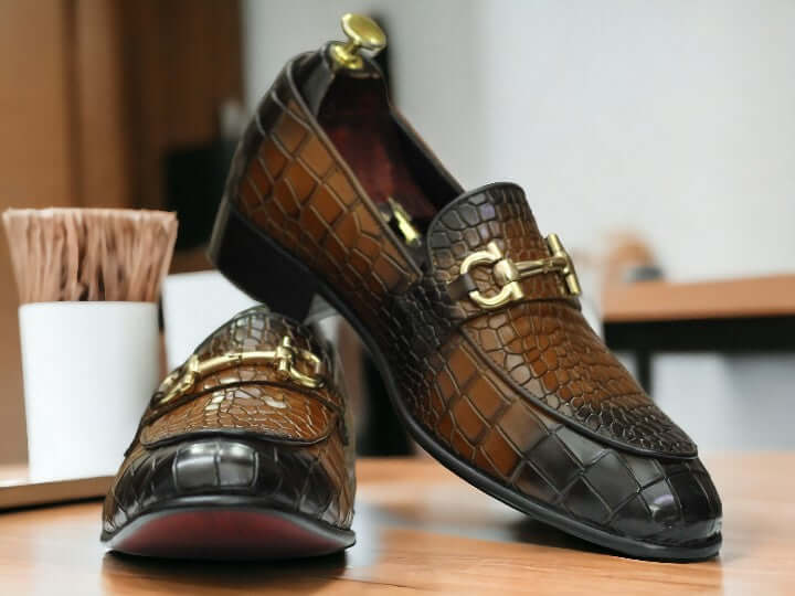 Expertly crafted for the refined gentleman, these Horse Bit Handmade Alligator Print Penny Loafer Shoes are a timeless addition to any wardrobe. Handmade with two-tone detailing, these shoes exude luxury and sophistication. Elevate your style and step out in confidence with these statement-making shoes.