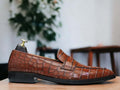 Expertly crafted for the discerning gentleman, our Handmade Alligator Print Penny Loafer Shoes are the perfect combination of style and comfort. Made with genuine tan alligator print leather, these slip on loafers exude sophistication and quality. Elevate your wardrobe with these luxurious handmade shoes.