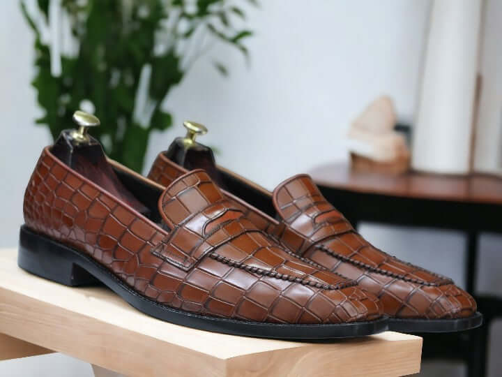 Expertly crafted for the discerning gentleman, our Handmade Alligator Print Penny Loafer Shoes are the perfect combination of style and comfort. Made with genuine tan alligator print leather, these slip on loafers exude sophistication and quality. Elevate your wardrobe with these luxurious handmade shoes.