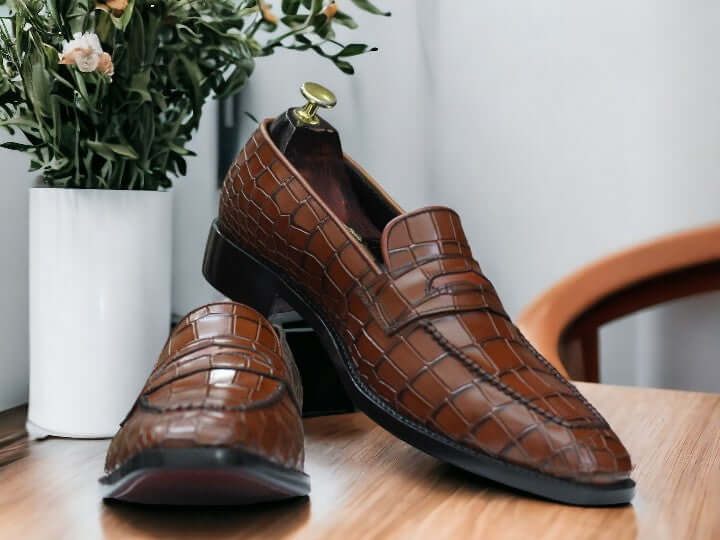 Expertly crafted for the discerning gentleman, our Handmade Alligator Print Penny Loafer Shoes are the perfect combination of style and comfort. Made with genuine tan alligator print leather, these slip on loafers exude sophistication and quality. Elevate your wardrobe with these luxurious handmade shoes.