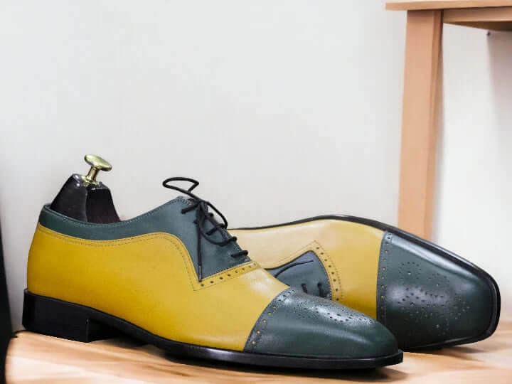 Expertly crafted with high-quality leather, these handmade Green Yellow Oxfords feature a stylish cap toe design. Elevate your wardrobe with these designer shoes that are perfect for any occasion. Enjoy the unique combination of green and yellow, making these Oxfords stand out from the rest.