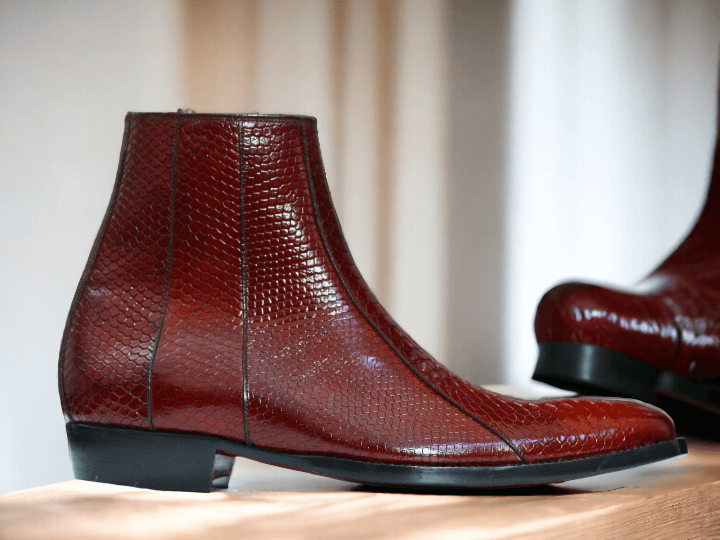 Expertly crafted with genuine python leather, these ankle-high dress boots make a bold statement. Handmade to perfection, their unique print adds a touch of luxury to any look. Elevate your style with these premium boots and experience ultimate comfort and sophistication.