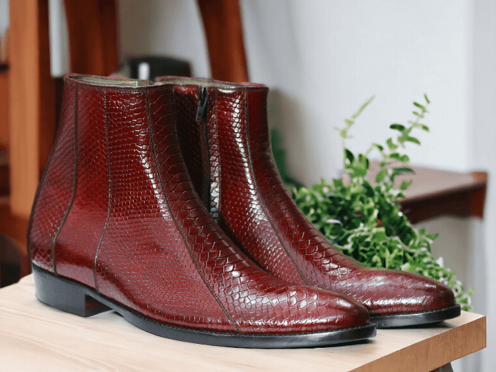 Expertly crafted with genuine python leather, these ankle-high dress boots make a bold statement. Handmade to perfection, their unique print adds a touch of luxury to any look. Elevate your style with these premium boots and experience ultimate comfort and sophistication.