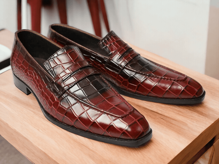 Expertly crafted and handmade, these men's red alligator print shoes offer a unique and stylish addition to any outfit. Slip on design for easy wear. The alligator print adds a touch of sophistication. Perfect for any occasion.