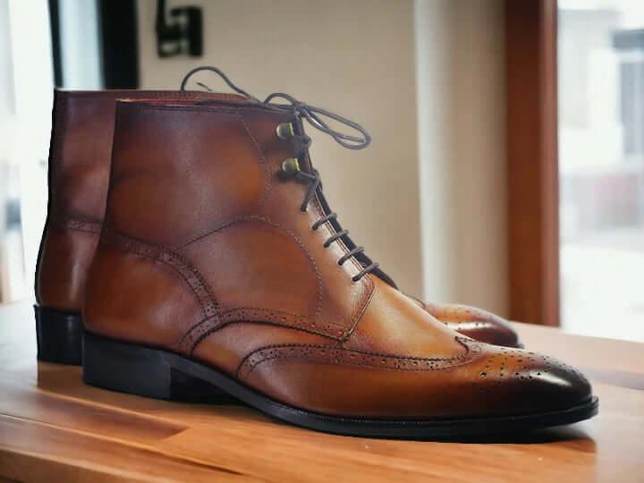 Step out in style with our Men's Ankle High Wing Tip Dress Boots, seamlessly blending classic and fashionable aesthetics. Crafted from brown leather, these boots not only elevate your style but also provide essential ankle-high support. Whether it's a formal event or a dressy occasion, these boots are a must-have for the fashion-forward man