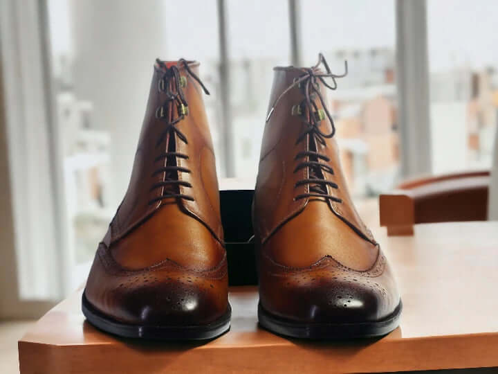 Step out in style with our Men's Ankle High Wing Tip Dress Boots, seamlessly blending classic and fashionable aesthetics. Crafted from brown leather, these boots not only elevate your style but also provide essential ankle-high support. Whether it's a formal event or a dressy occasion, these boots are a must-have for the fashion-forward man