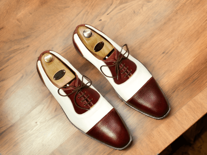 Expertly handcrafted from high-quality materials, these Men's White Burgundy Cap Toe Shoes combine classic style and superior comfort. Perfect for formal occasions, the lace-up design and cap toe add a touch of sophistication to any outfit. Elevate your look with these designer shoes that are sure to impress.