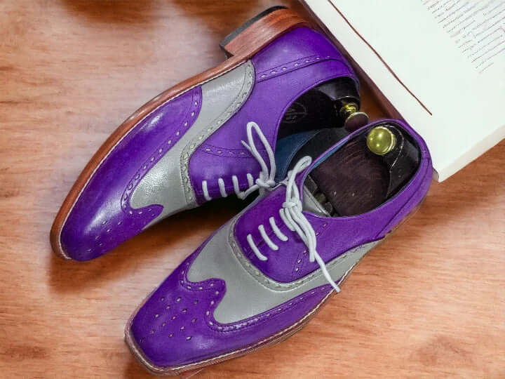 Elevate your style with our designer men's purple grey leather dress shoes. Crafted with precision and attention to detail, these brogue oxfords add a touch of sophistication to any outfit. Made from high-quality leather, these shoes provide both durability and comfort. Perfect for any formal occasion, impress with every step.