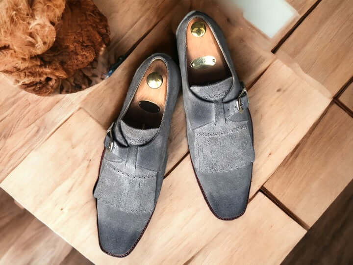 Handcrafted for durability and style, these Handmade Grey Suede Fringe Loafer Shoes elevate any outfit. Made with supple suede and finished with a sophisticated buckle, they provide a comfortable fit and timeless look. Step up your shoe game with these men's loafer shoes.