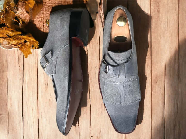 Handcrafted for durability and style, these Handmade Grey Suede Fringe Loafer Shoes elevate any outfit. Made with supple suede and finished with a sophisticated buckle, they provide a comfortable fit and timeless look. Step up your shoe game with these men's loafer shoes.