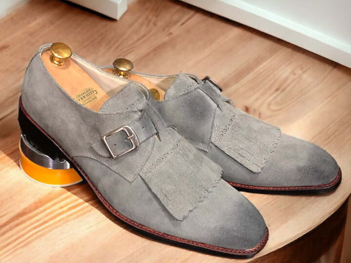 Handcrafted for durability and style, these Handmade Grey Suede Fringe Loafer Shoes elevate any outfit. Made with supple suede and finished with a sophisticated buckle, they provide a comfortable fit and timeless look. Step up your shoe game with these men's loafer shoes.