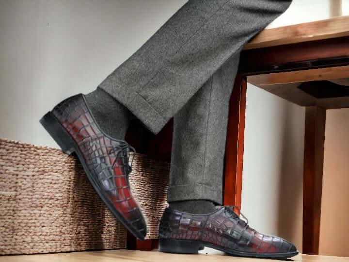 Expertly crafted for durability, these handmade Oxfords showcase a unique alligator print, adding a touch of sophistication to any outfit. Perfect for the stylish and practical man, these shoes are built to last and elevate your wardrobe.