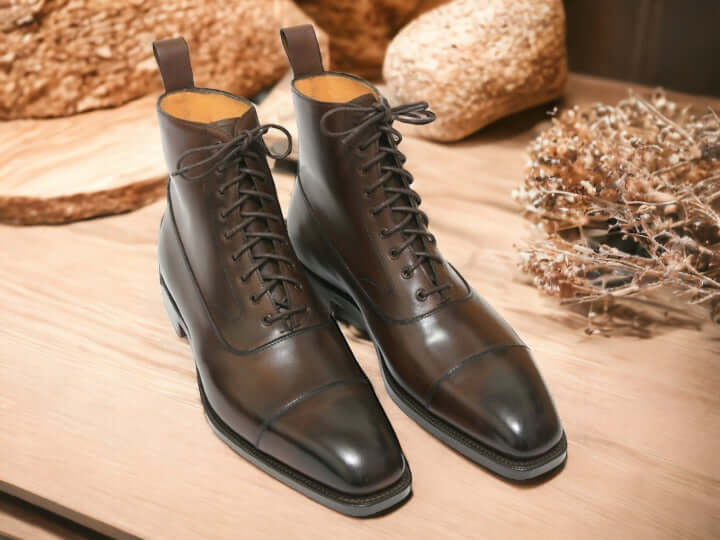 Ankle High Chocolate Brown Cap Toe Lace-Up Boots are expertly crafted from luxuriously soft and durable cowhide leather. This classically designed men's boot features a lace-up front and a traditional cap toe design that adds a timeless touch to any wardrobe.