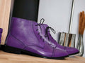 Expertly crafted with vibrant hand-painted purple leather, these ankle high boots are a unique addition to any wardrobe. The high-quality leather offers durability and style, while the ankle height provides excellent support and comfort. Add a pop of color to your outfit with these one-of-a-kind boots.