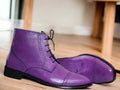 Expertly crafted with vibrant hand-painted purple leather, these ankle high boots are a unique addition to any wardrobe. The high-quality leather offers durability and style, while the ankle height provides excellent support and comfort. Add a pop of color to your outfit with these one-of-a-kind boots.