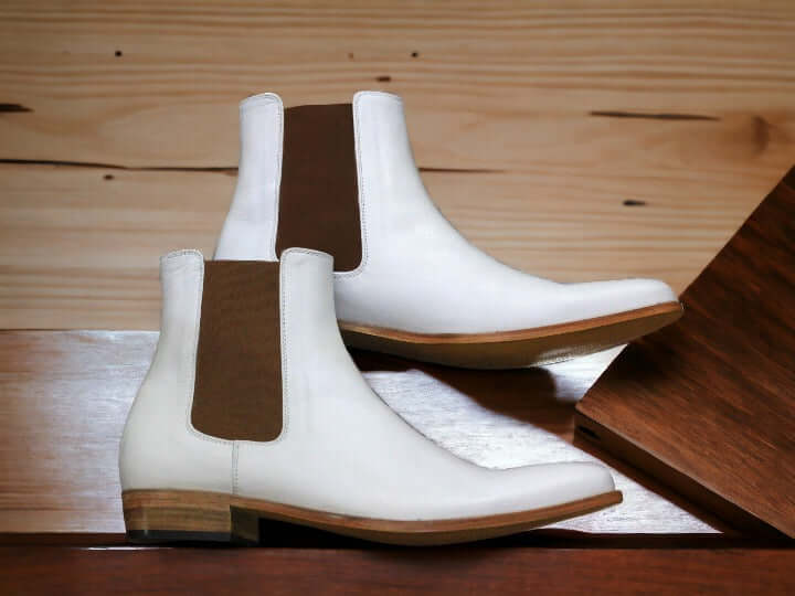 Expertly crafted by hand, our pure white leather boot exudes luxury and style. The sleek design of the men's Chelsea boot adds a touch of sophistication to any outfit. Made from genuine leather, it's a durable and high-quality addition to your wardrobe. Elevate your fashion game with this must-have luxury boot.