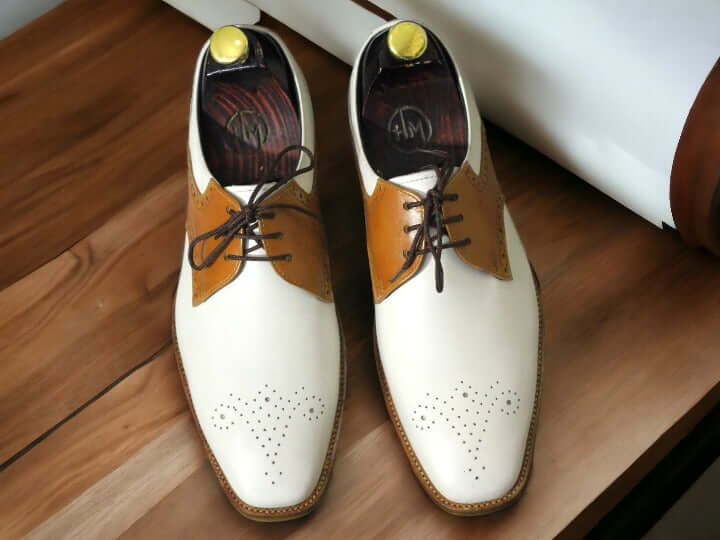 Expertly crafted for the modern man, these Handmade Men's Brown White Brogue Toe Lace Up Office Shoes exude sophistication and style. Handmade with care, these shoes feature a classic brogue toe design and lace up closure for a timeless look. Elevate your office attire with these high-quality shoes.