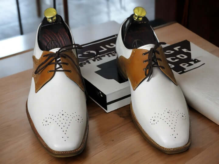 Expertly crafted for the modern man, these Handmade Men's Brown White Brogue Toe Lace Up Office Shoes exude sophistication and style. Handmade with care, these shoes feature a classic brogue toe design and lace up closure for a timeless look. Elevate your office attire with these high-quality shoes.