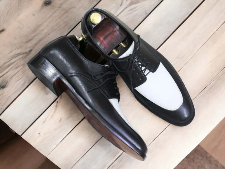 Introducing our Men's Black & White Derby Leather Shoes - the perfect addition to any sophisticated wardrobe. Made from high-quality leather, these shoes offer both style and durability. With a sleek black and white design, they are sure to make a statement. Elevate your look and step out in confidence with our Derby Shoes.