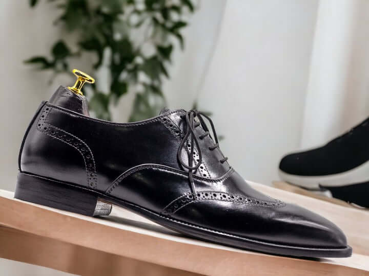 These timeless handmade men's black wingtip oxford shoes feature classic detailing for a sophisticated look. Crafted with superior quality leather, they are finished with a durable rubber sole for long-lasting wear. Perfect for formal or business events.