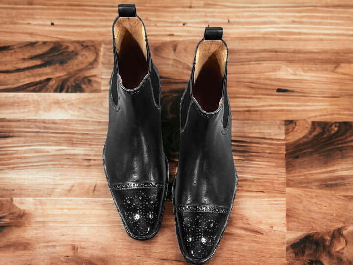 These stylish designer handmade Black Chelsae Brogue Boots are the perfect addition to any man's wardrobe. Crafted with quality leather and hand stitching, these boots provide a comfortable fit with a timeless look. They offer a sophisticated style with a unique embossed texture.