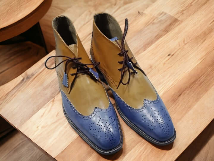 These handmade two-tone chukka boots are crafted with durable leather and handpainted with a stylish blue tan combination. The sophisticated design is perfect for any formal or casual occasion.