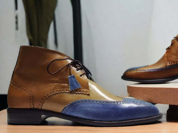 These handmade two-tone chukka boots are crafted with durable leather and handpainted with a stylish blue tan combination. The sophisticated design is perfect for any formal or casual occasion.