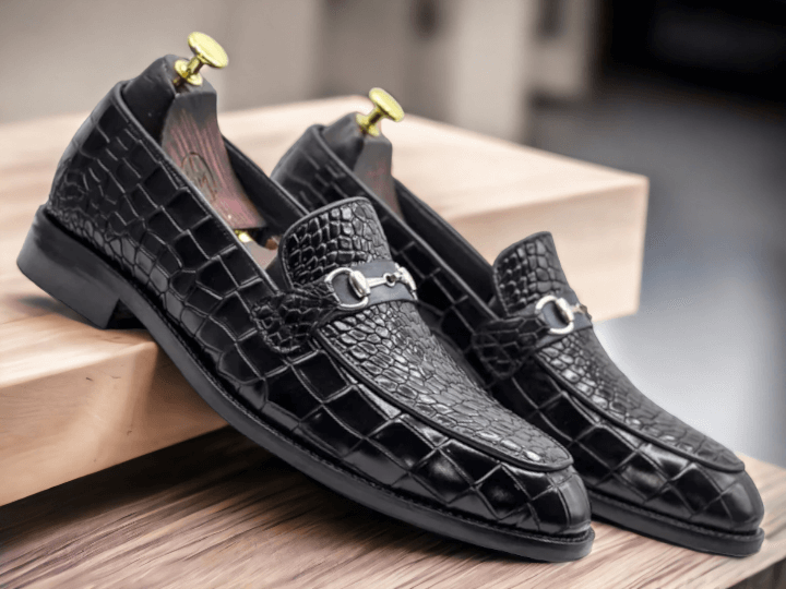 Handmade with genuine black alligator leather, these slip-on shoes offer a touch of luxury to any outfit. The intricate handcrafted design and stylish black alligator print make them a sophisticated choice for any occasion. Slip into comfort and elegance with these handmade alligator loafers.