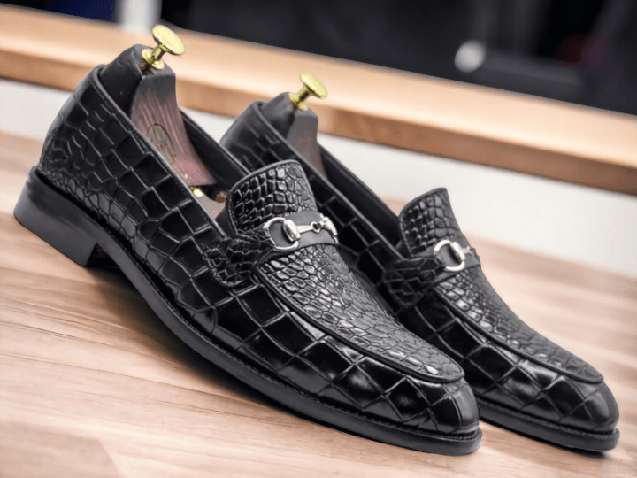 Handmade with genuine black alligator leather, these slip-on shoes offer a touch of luxury to any outfit. The intricate handcrafted design and stylish black alligator print make them a sophisticated choice for any occasion. Slip into comfort and elegance with these handmade alligator loafers.